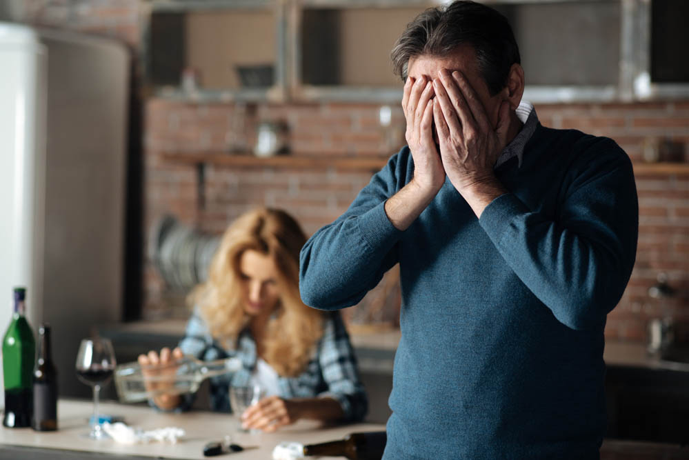 Disappointed man covering his face